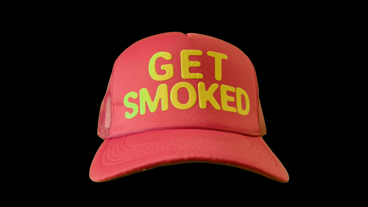 Front of red GET SMOKED anime trucker hat with yellow 3D puff lettering